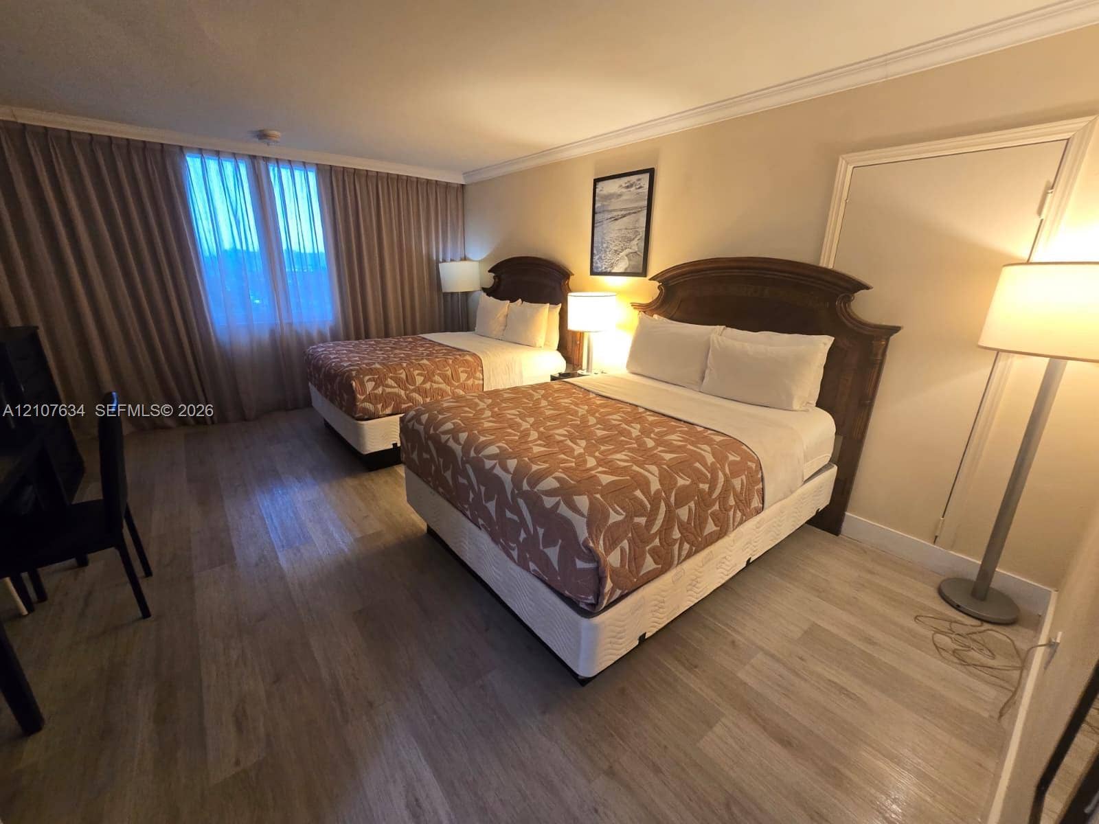 19201 Collins Avenue, #941, Sunny Isles Beach, FL 33160 Room featuring wood-finish flooring, full-height window drapery, and crown molding