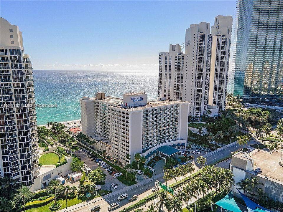 19201 Collins Avenue, #941, Sunny Isles Beach, FL 33160 Aerial perspective of a high-rise residential complex featuring oceanfront positioning, direct access to the coastline, landscaped grounds, and proximity to major roadways