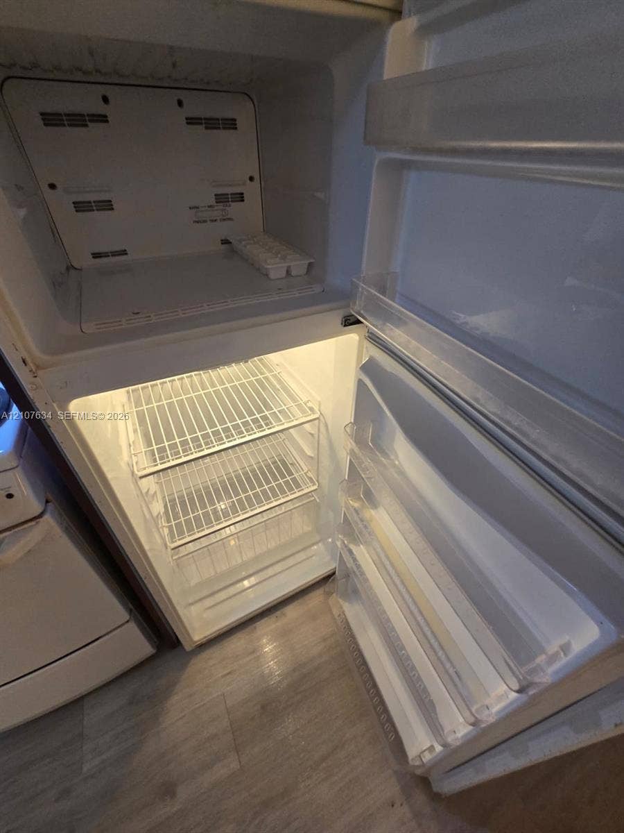 19201 Collins Avenue, #941, Sunny Isles Beach, FL 33160 Top-mount refrigerator featuring wire shelving, door storage bins, and integrated interior lighting