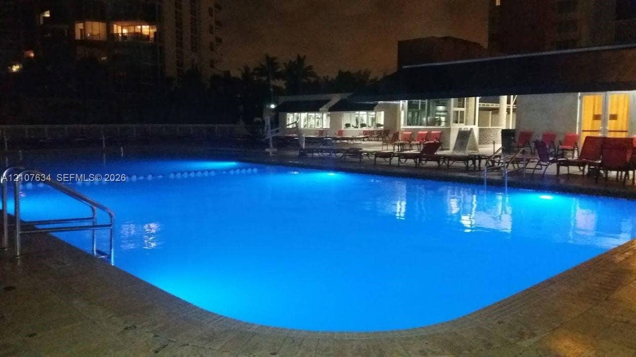 19201 Collins Avenue, #941, Sunny Isles Beach, FL 33160 Rectangular swimming pool featuring a stone-tile deck and built-in metal handrails
