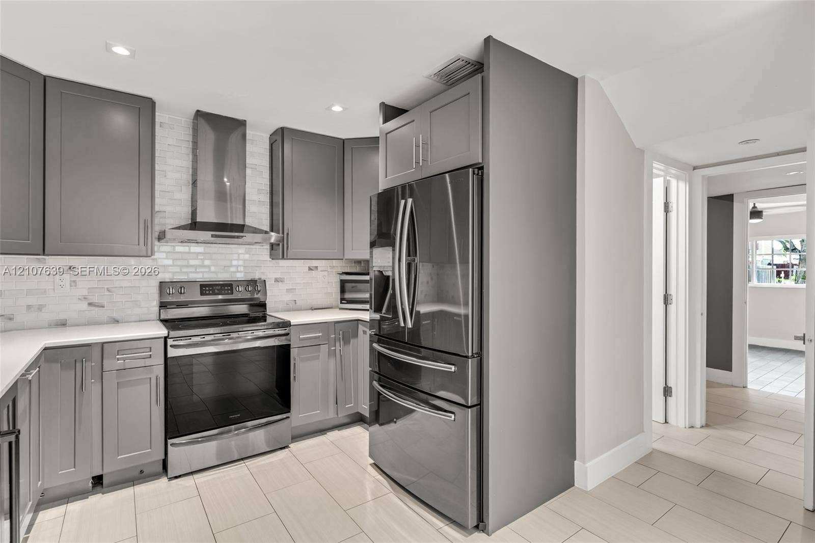 11735 SW 114th Terrace, #11735, Miami, Miami, FL 33186 Kitchen featuring grey shaker-style cabinetry, white tile backsplash, stainless steel appliances, and large-format floor tile