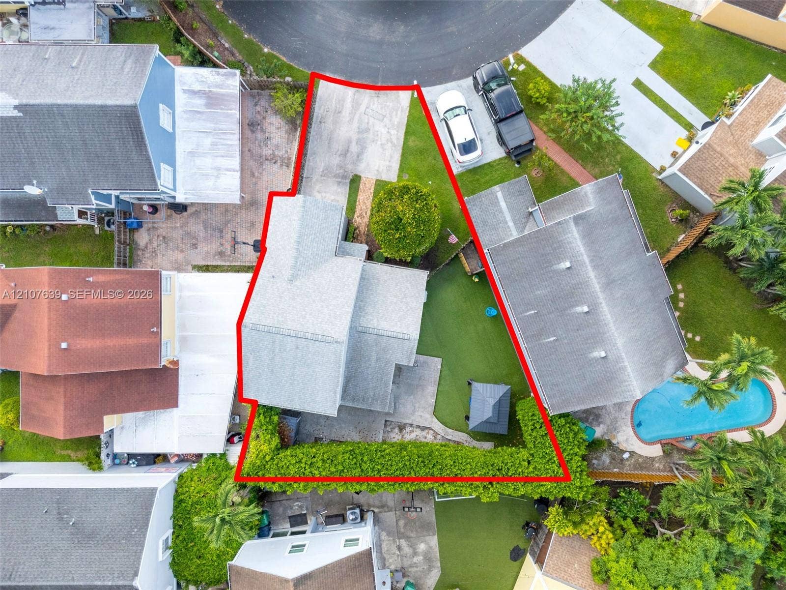 11735 SW 114th Terrace, #11735, Miami, Miami, FL 33186 Cul-de-sac property featuring a concrete driveway, paved rear patio, and mature perimeter hedging
