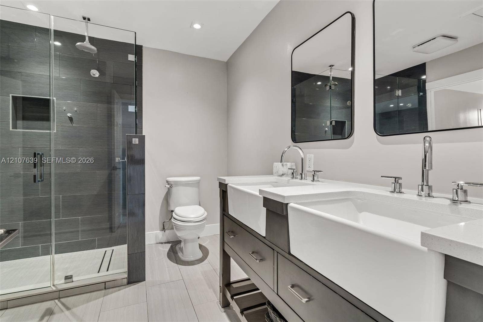 11735 SW 114th Terrace, #11735, Miami, Miami, FL 33186 Double vanity featuring farmhouse-style sinks, quartz countertops, glass-enclosed shower with tiled walls, and dual rectangular wall-mounted mirrors