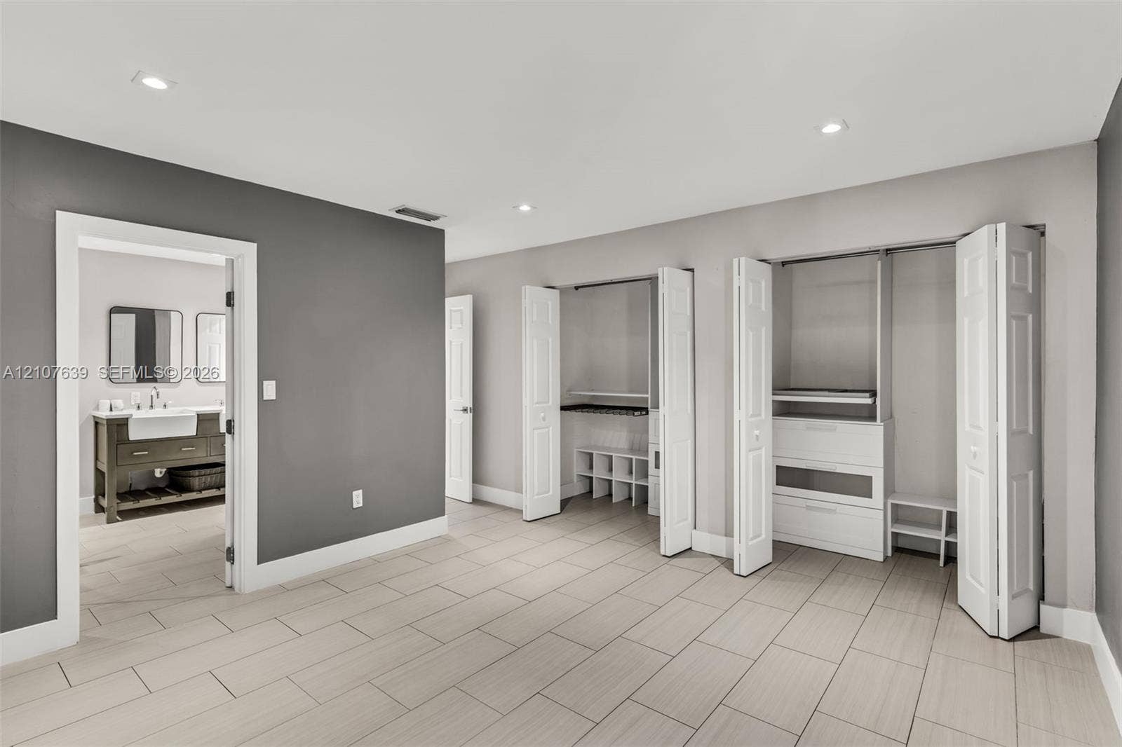 11735 SW 114th Terrace, #11735, Miami, Miami, FL 33186 Ceramic tile flooring, recessed lighting, dual closets with interior built-in shelving, and entry to bathroom featuring a wooden vanity with undermount sink