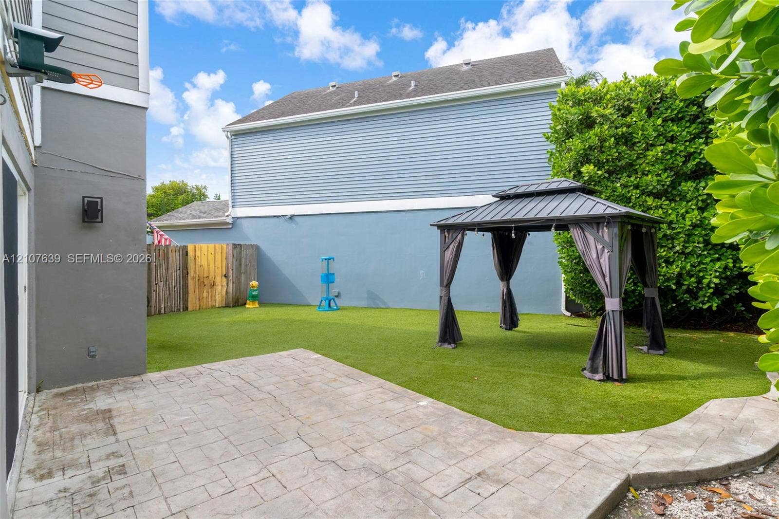 11735 SW 114th Terrace, #11735, Miami, Miami, FL 33186 Fenced backyard featuring synthetic turf, paver patio, and metal gazebo