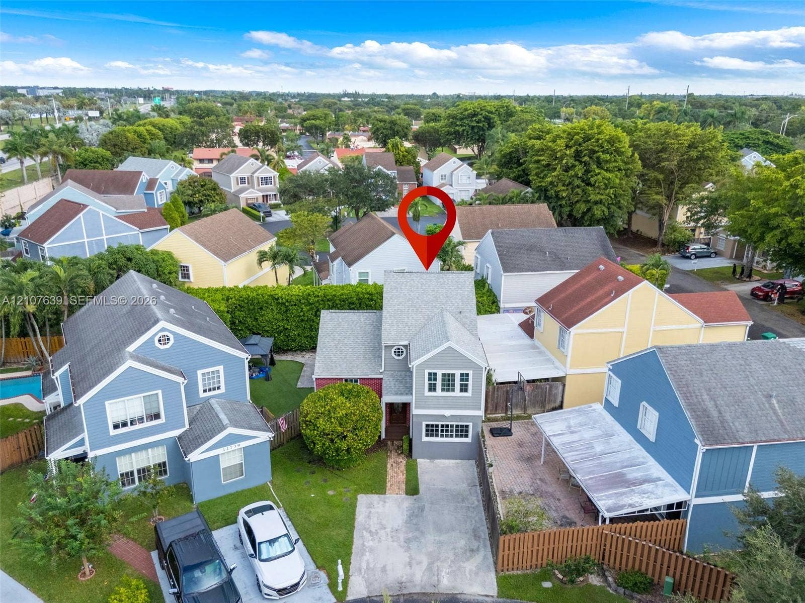 11735 SW 114th Terrace, #11735, Miami, Miami, FL 33186 Two-story residential structure featuring a shingled roof, horizontal siding, and a paved driveway
