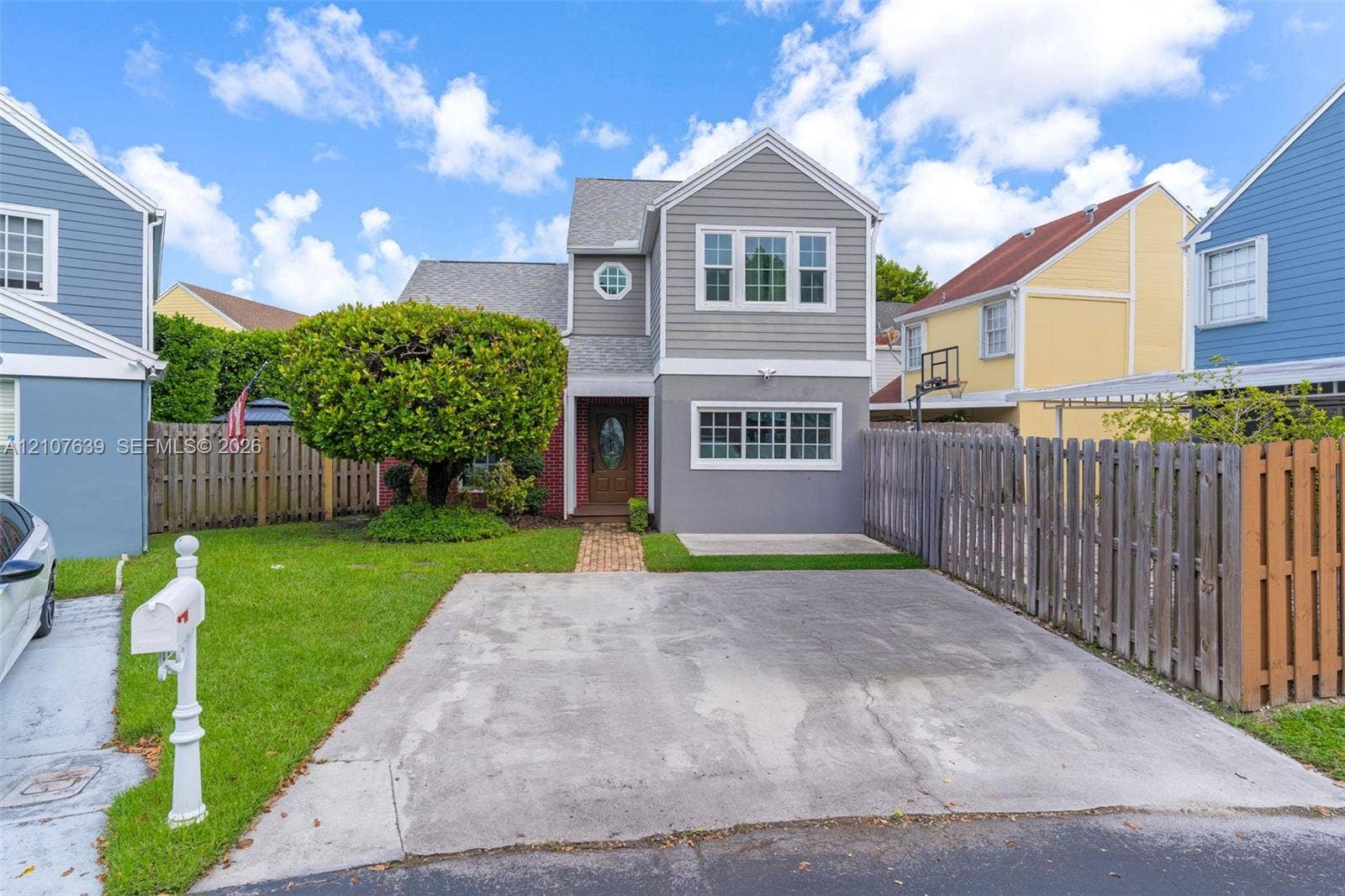 11735 SW 114th Terrace, #11735, Miami, Miami, FL 33186 Multi-story residence with horizontal siding, brick masonry, asphalt shingle roofing, paved driveway, and manicured lawn