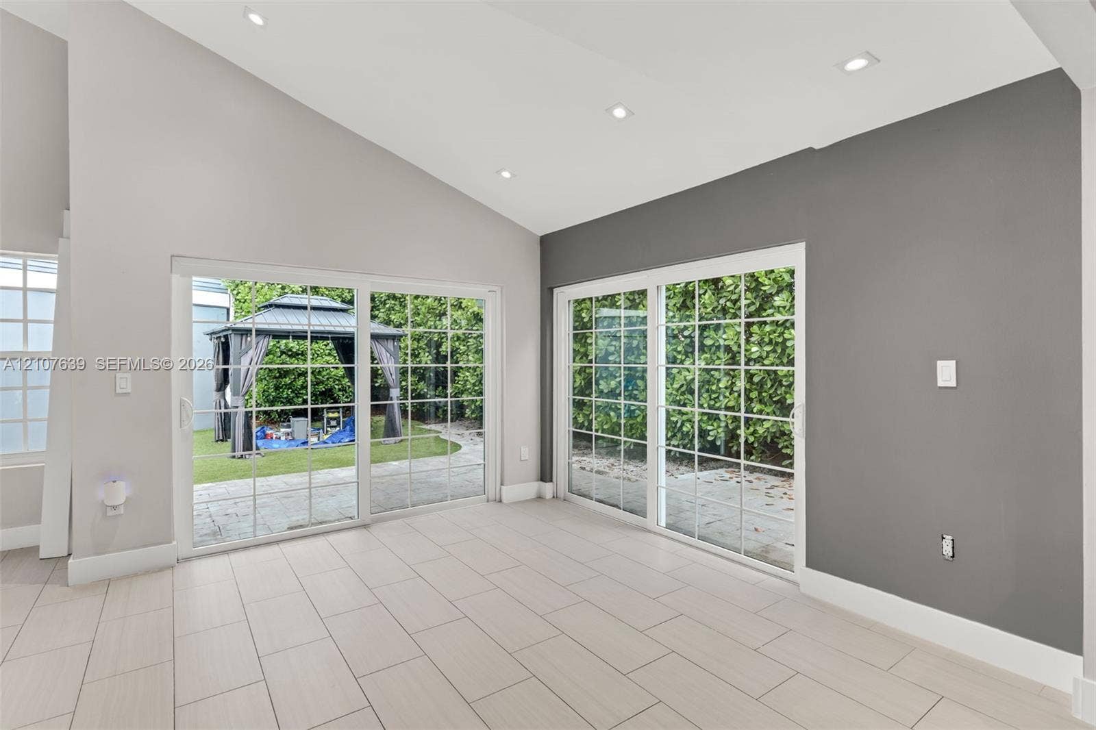 11735 SW 114th Terrace, #11735, Miami, Miami, FL 33186 Vaulted ceilings, large-format tile flooring, dual sliding glass doors, and recessed lighting