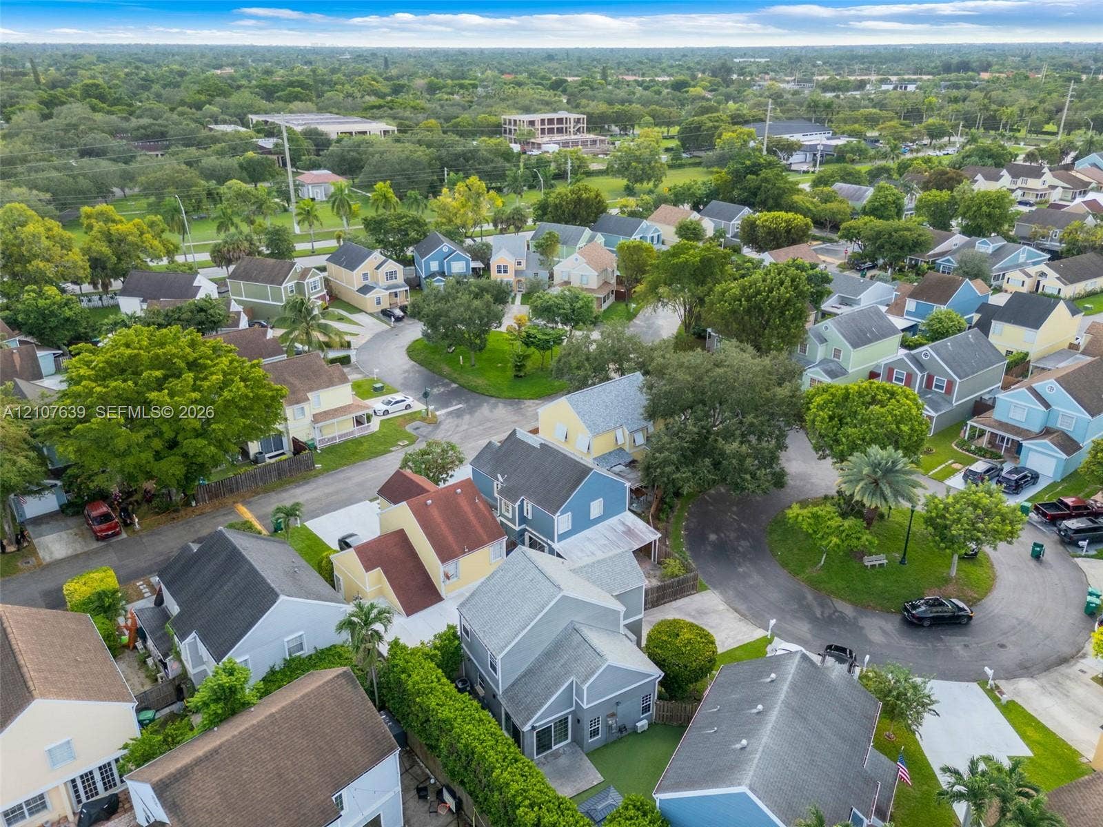 11735 SW 114th Terrace, #11735, Miami, Miami, FL 33186 Aerial perspective of a residential neighborhood featuring paved streets, mature trees, manicured landscaping, and detached single-family dwellings with diverse rooflines