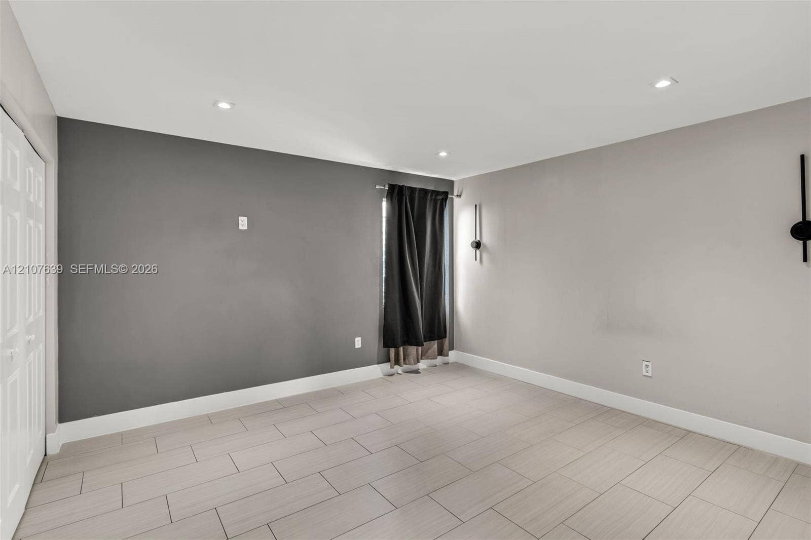 11735 SW 114th Terrace, #11735, Miami, Miami, FL 33186 Interior space featuring neutral wall tones, large-format tile flooring, recessed ceiling lighting, and dual wall-mounted light fixtures