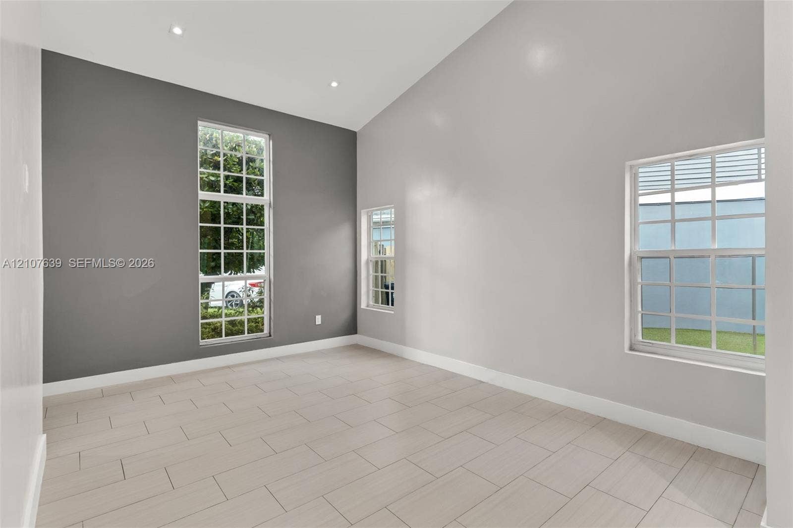 11735 SW 114th Terrace, #11735, Miami, Miami, FL 33186 Vaulted ceilings featuring recessed lighting, large grid-pattern windows, and neutral-tone tile flooring
