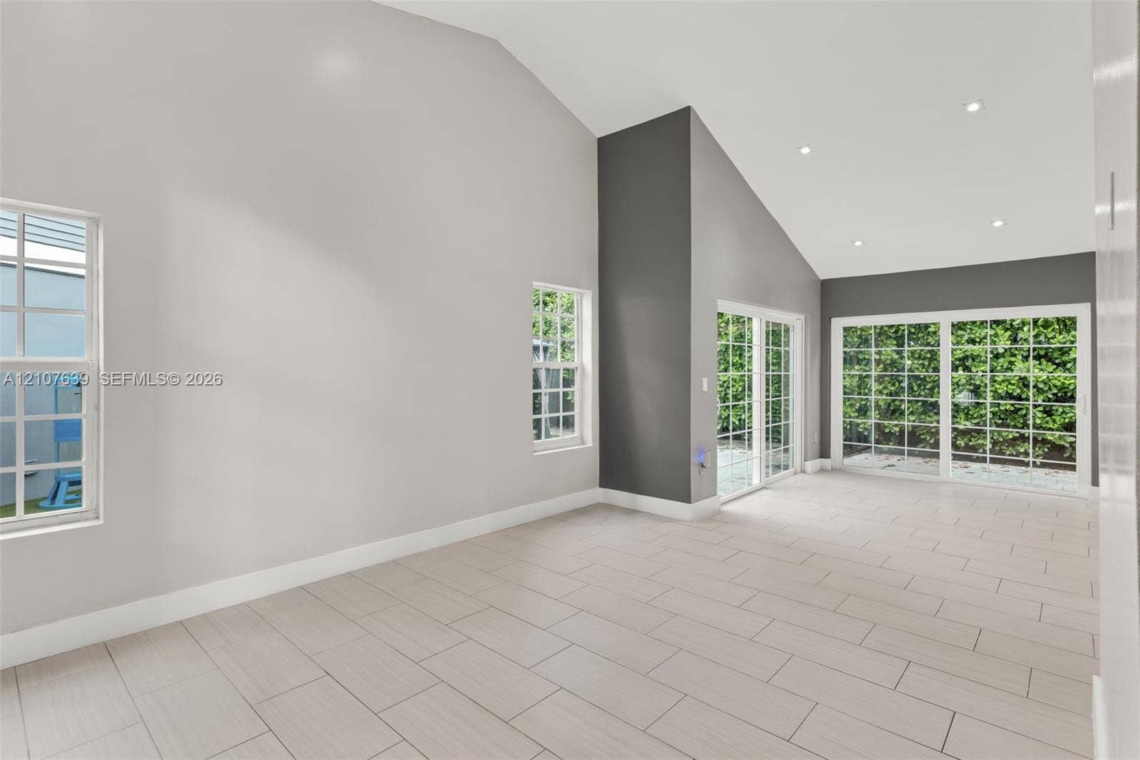 11735 SW 114th Terrace, #11735, Miami, Miami, FL 33186 Vaulted ceiling with recessed lighting, tile flooring, and dual sliding glass doors