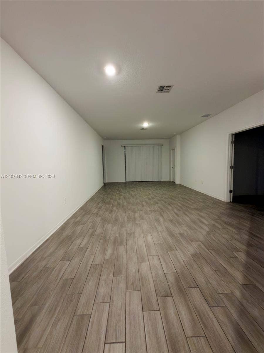 664 Tanaro Lane, Haines City, FL 33844 Interior space featuring wood-finish tile flooring, neutral wall paint, and recessed ceiling lighting
