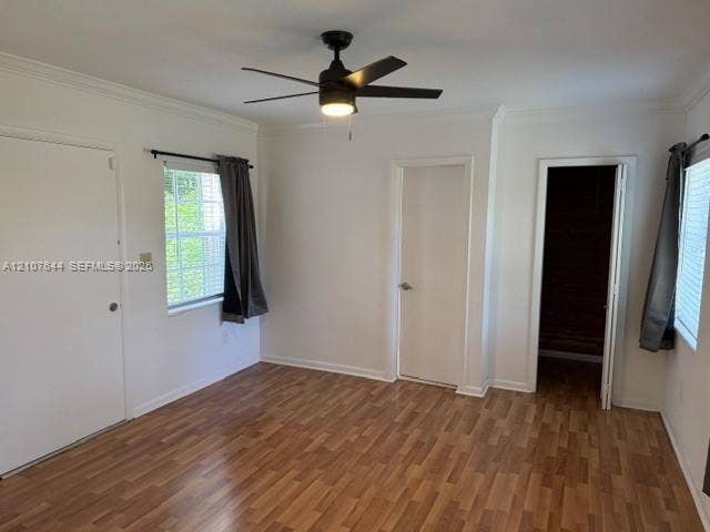7550 SW 67th Avenue, South Miami, South Miami, FL 33143 Wood-finish flooring, matte black ceiling fan with integrated lighting, dual windows with multi-pane glazing, and interior doors with satin finish hardware