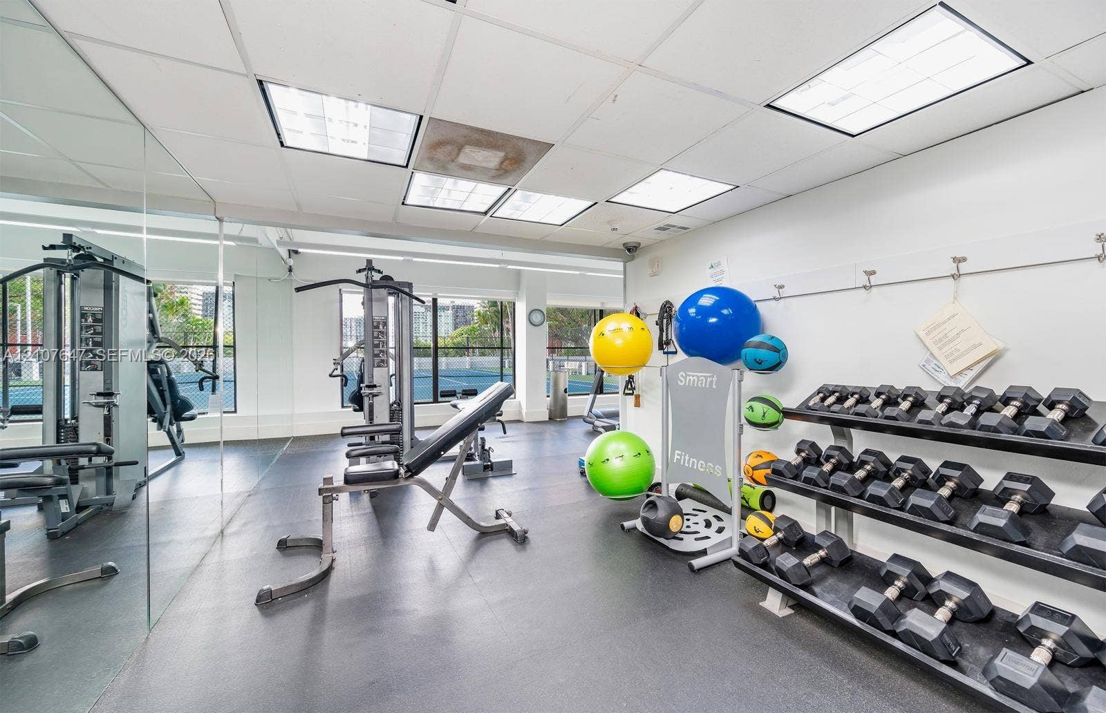200 SE 15th Road, #PH-A, Miami, Miami, FL 33129 Fitness area featuring large-scale wall mirrors, recessed drop-ceiling lighting, and heavy-duty rubber flooring