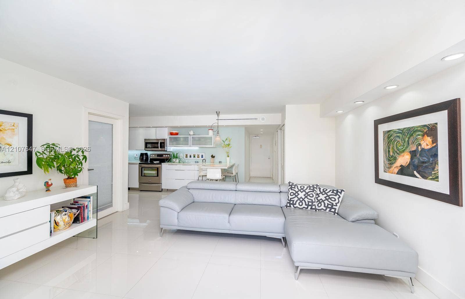 200 SE 15th Road, #PH-A, Miami, Miami, FL 33129 Open-concept living space featuring high-gloss white cabinetry, stainless steel appliances, recessed ceiling lighting, and polished tile flooring