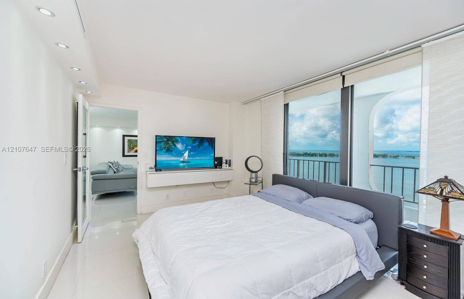 200 SE 15th Road, #PH-A, Miami, Miami, FL 33129 Floor-to-ceiling windows with balcony access, recessed ceiling lighting, light-colored polished flooring, and wall-mounted floating cabinetry