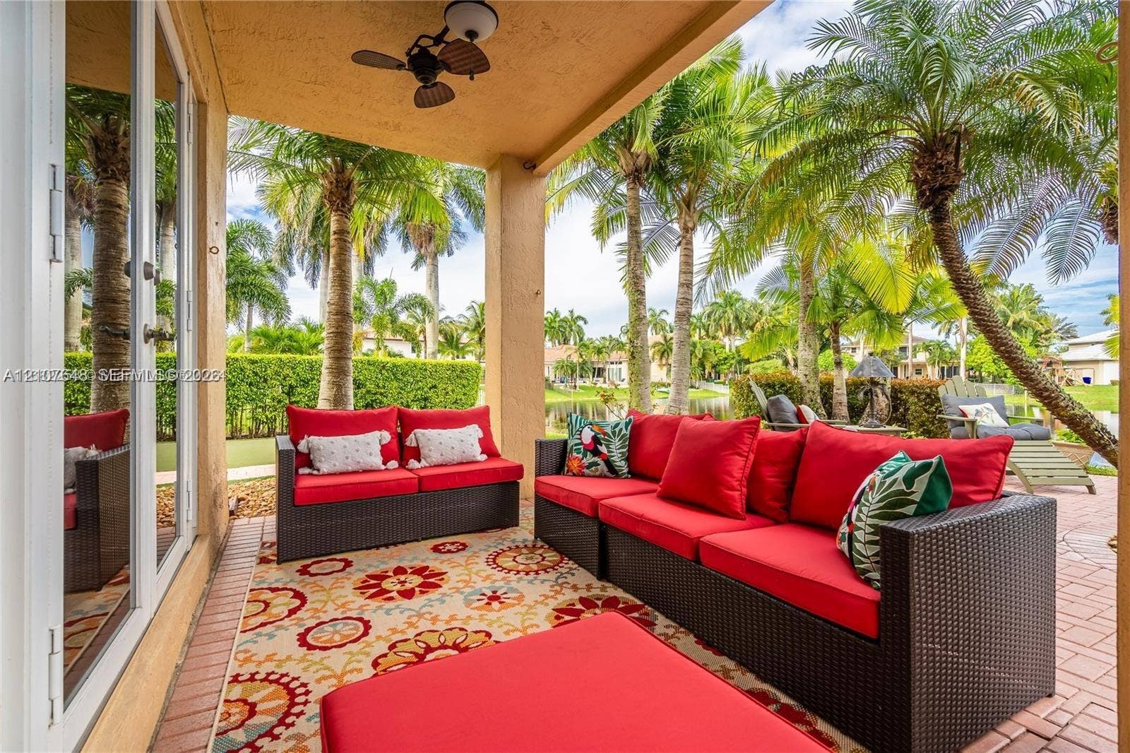 Covered patio featuring a paved floor, a ceiling-mounted fan, and glass French doors