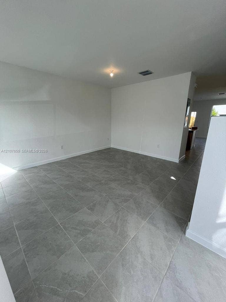 1787 SE 26th Terrace, Homestead, Homestead, FL 33035 Interior space featuring neutral wall tones and large-format porcelain tile flooring
