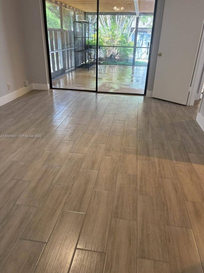 Wood-finish flooring, sliding glass door, and screened-in patio area