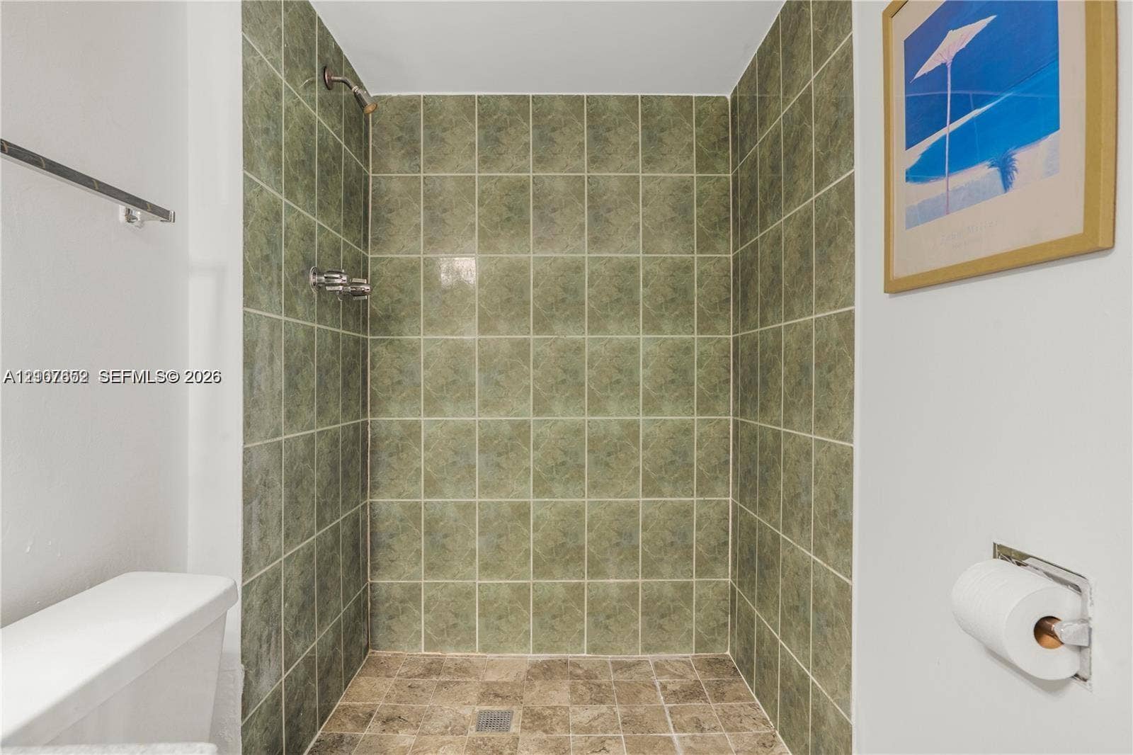 20500 W Country Club Drive, #607, Aventura, Aventura, FL 33180 Walk-in shower featuring floor-to-ceiling green square tile surround, stone-finish floor tiling, and a metallic shower fixture