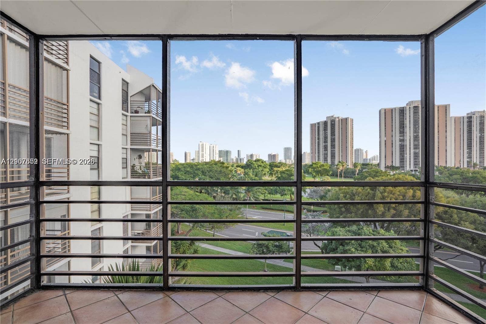 20500 W Country Club Drive, #607, Aventura, Aventura, FL 33180 Enclosed balcony featuring tile flooring and metal screen framing
