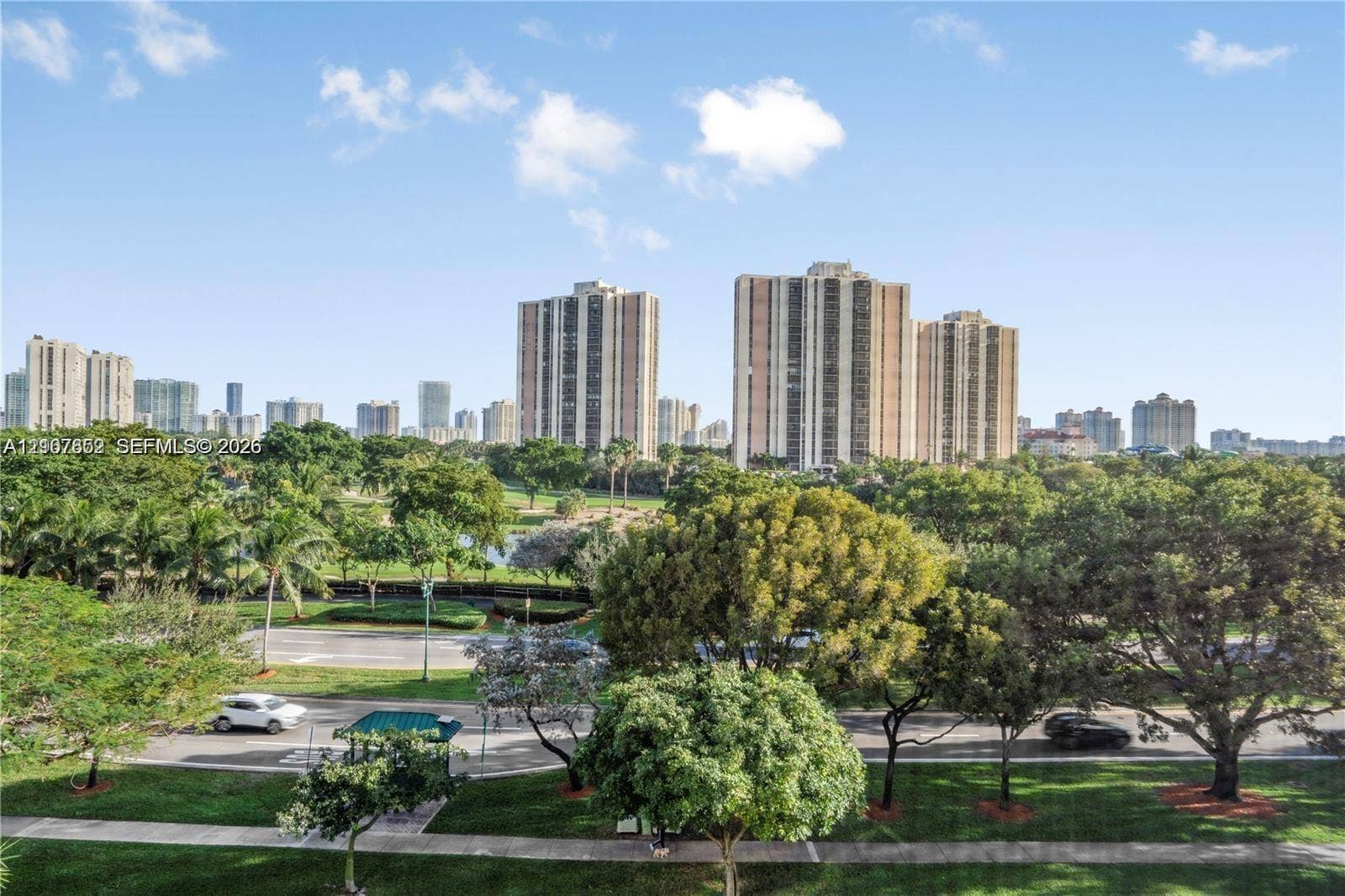 20500 W Country Club Drive, #607, Aventura, Aventura, FL 33180 Panoramic urban skyline backdrop featuring expansive parkland, mature landscaping, and paved pedestrian pathways