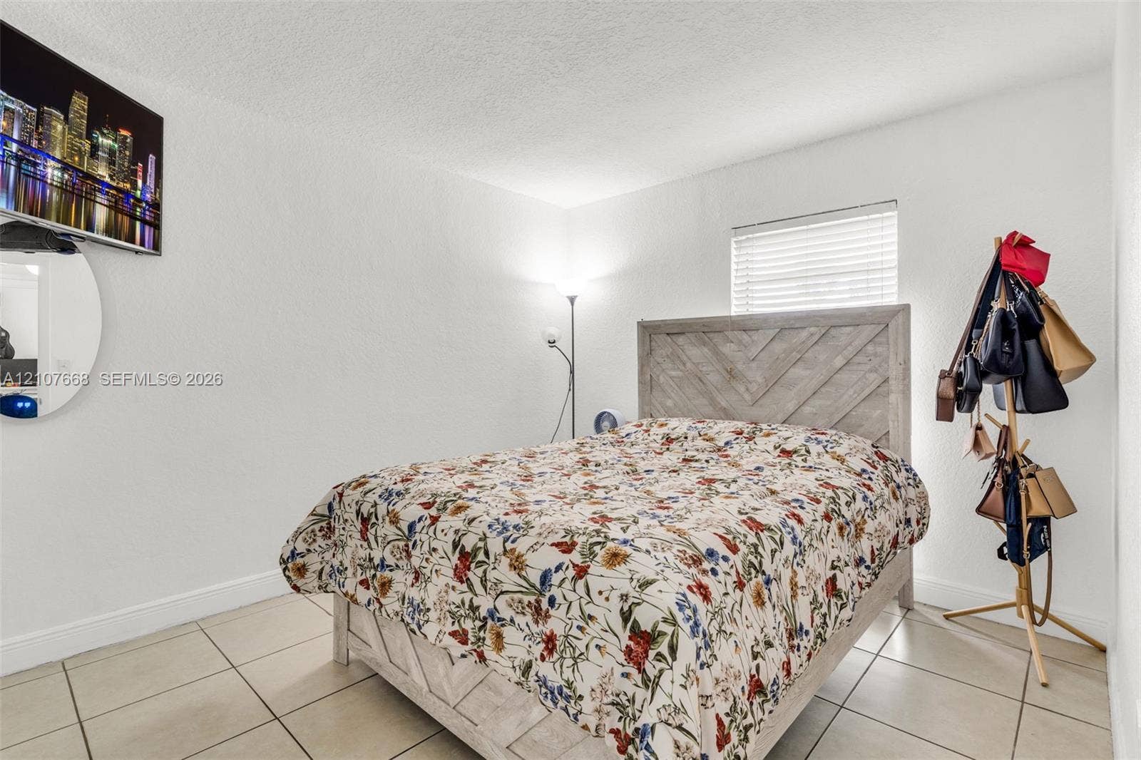 7245 SW 94th Place, #K4, Miami, FL 33173 Neutral-toned tile flooring, textured ceiling, and a horizontal slat window blind