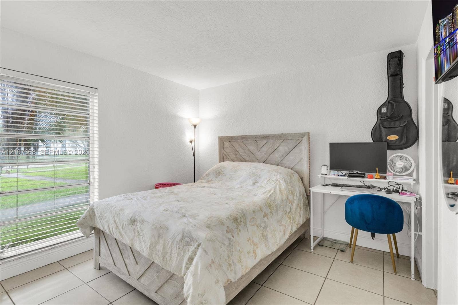 7245 SW 94th Place, #K4, Miami, FL 33173 Neutral-toned tile flooring, white wall finish, and large window with horizontal blinds