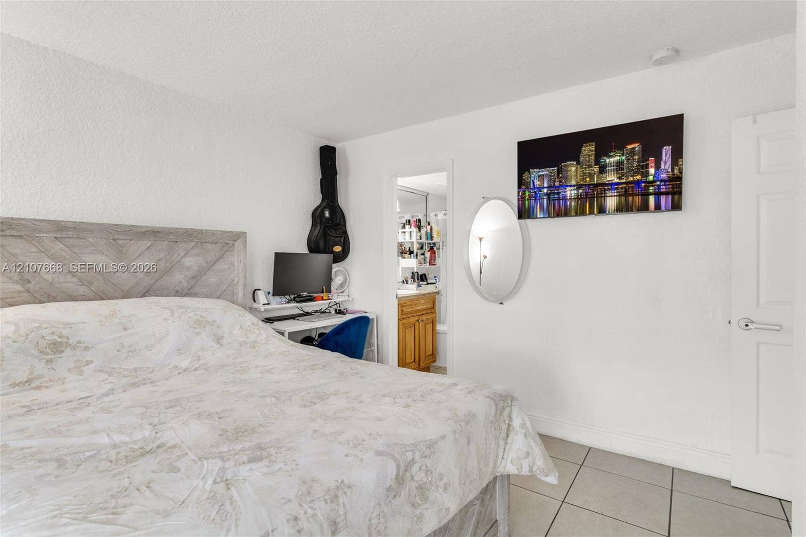 7245 SW 94th Place, #K4, Miami, FL 33173 Neutral-toned tile flooring, white interior walls, and a six-panel door with a metallic lever handle