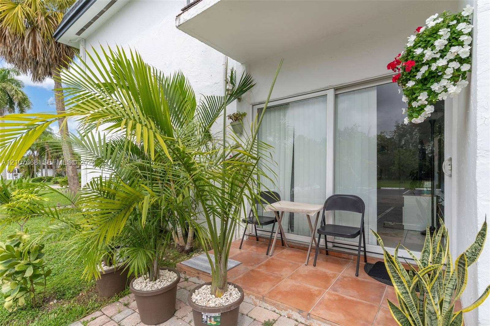 7245 SW 94th Place, #K4, Miami, FL 33173 Ground-level patio featuring terracotta-toned tile flooring and sliding glass door entry