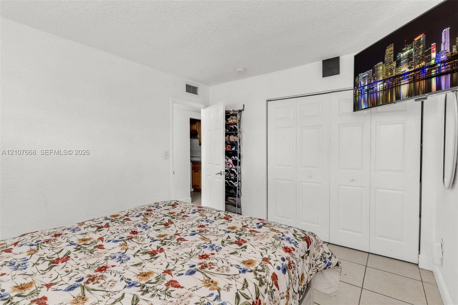 7245 SW 94th Place, #K4, Miami, FL 33173 Room featuring white walls, tile flooring, and a multi-panel closet with white doors