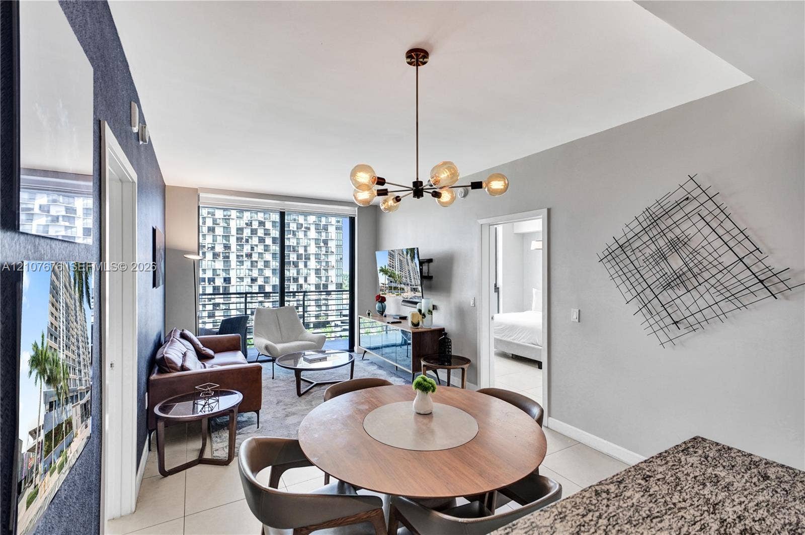 5350 NW 84th Avenue, #1004, Doral, FL 33166 Floor-to-ceiling windows, open-concept layout, modern multi-arm chandelier, and neutral tile flooring