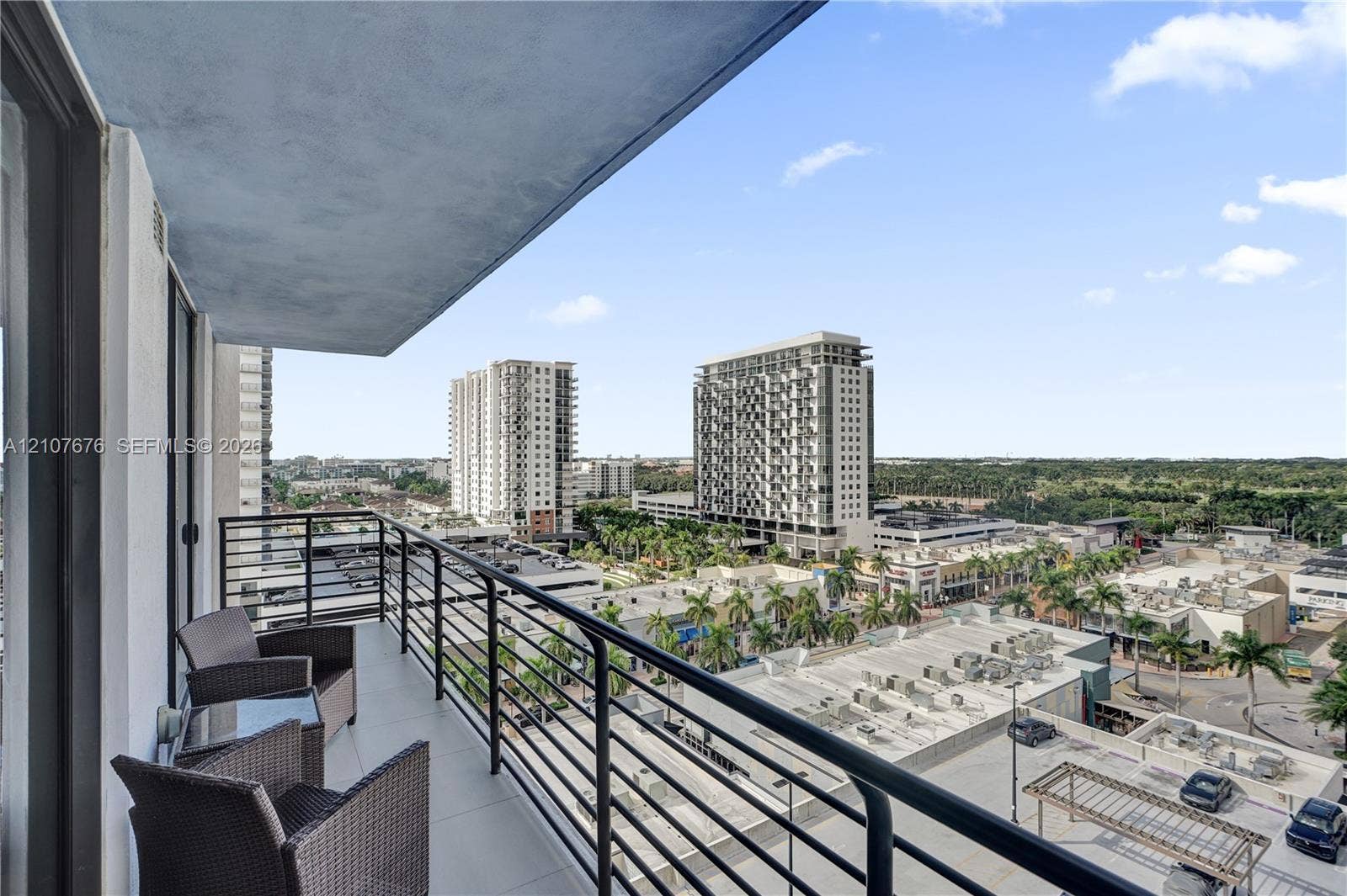 5350 NW 84th Avenue, #1004, Doral, FL 33166 Covered balcony featuring concrete flooring and a black metal railing