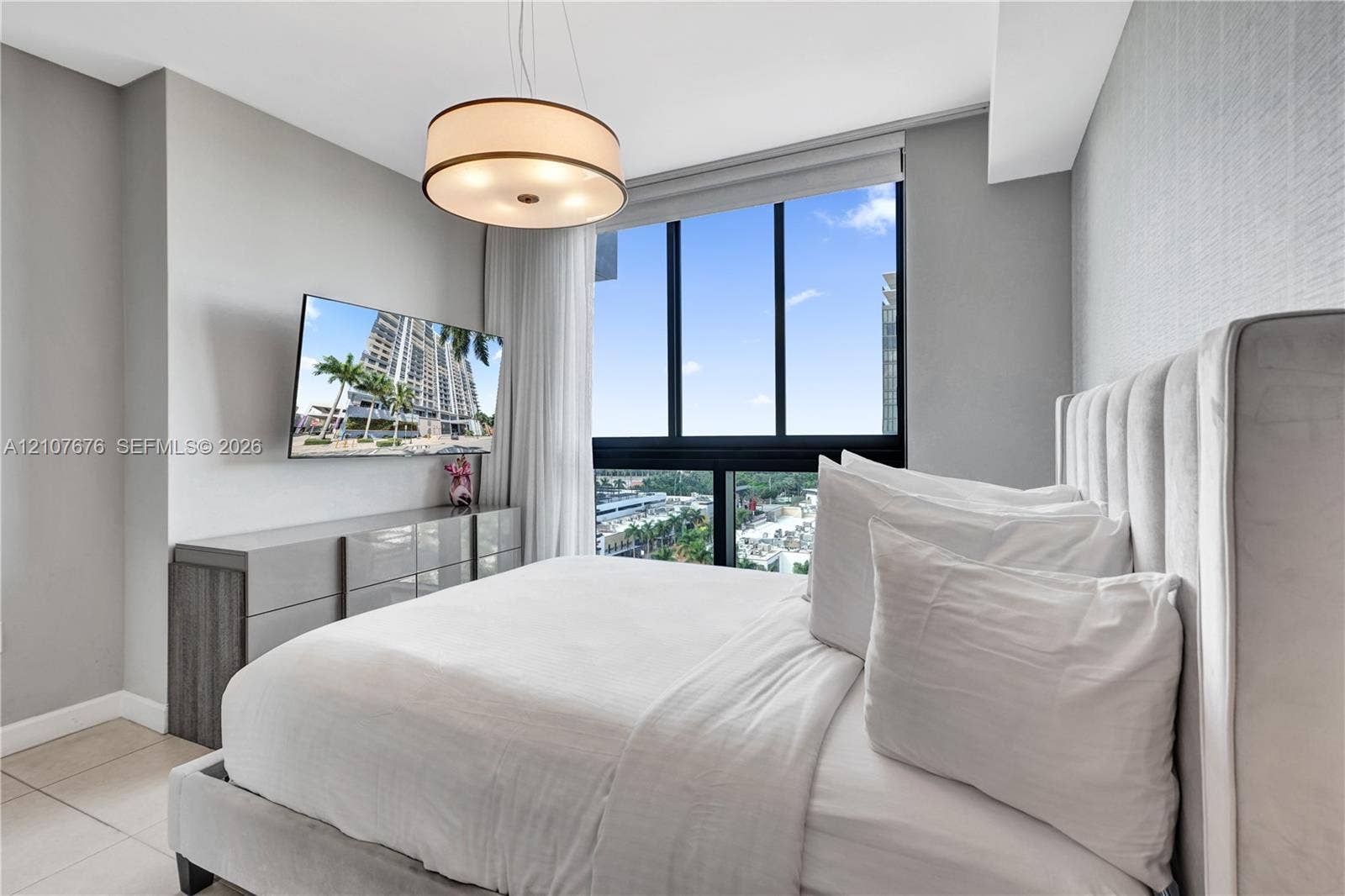 5350 NW 84th Avenue, #1004, Doral, FL 33166 Floor-to-ceiling windows, drum pendant lighting, neutral textured wall covering, and large-format tile flooring