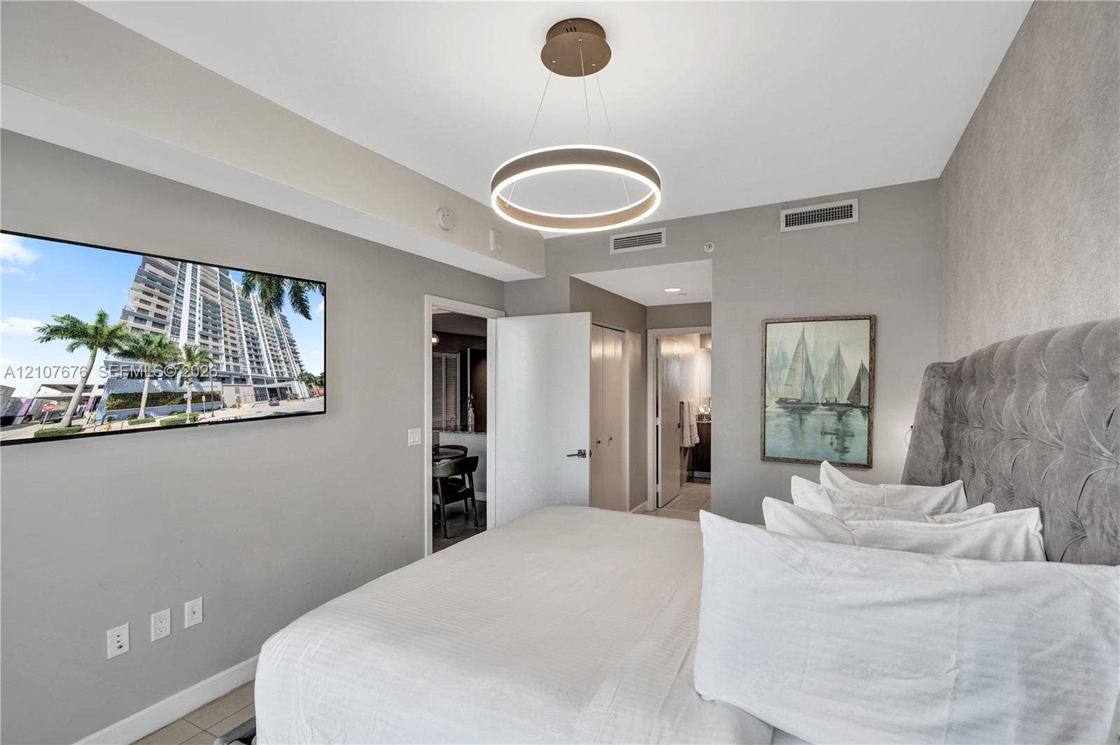 5350 NW 84th Avenue, #1004, Doral, FL 33166 Circular modern LED pendant light fixture, neutral wall color palette, and light-colored tile flooring