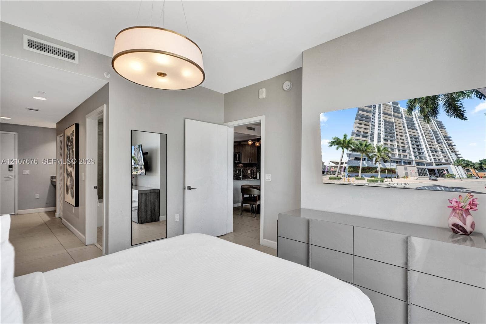 5350 NW 84th Avenue, #1004, Doral, FL 33166 Neutral-toned interior featuring large-format tile flooring, recessed lighting, and a circular drum pendant light fixture