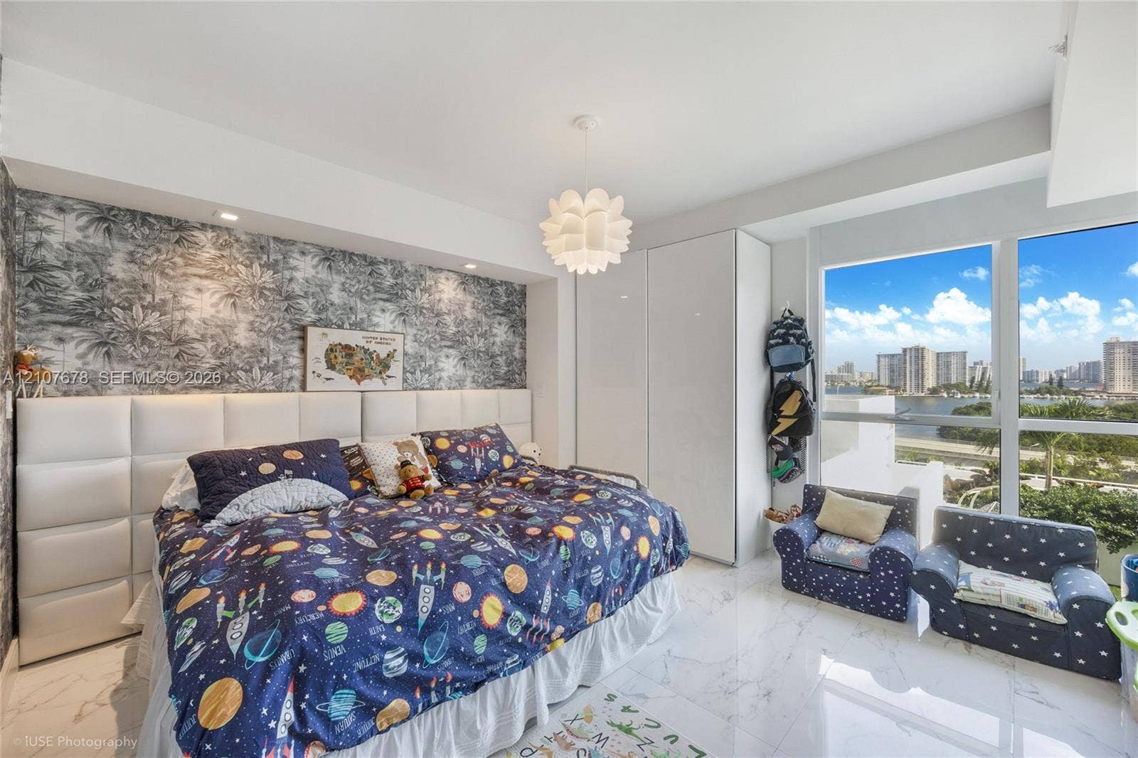 400 Sunny Isles Boulevard, #704, Sunny Isles Beach, FL 33160 Floor-to-ceiling windows, built-in floor-to-ceiling cabinetry with high-gloss finish, custom upholstered wall paneling, and polished stone-finish flooring