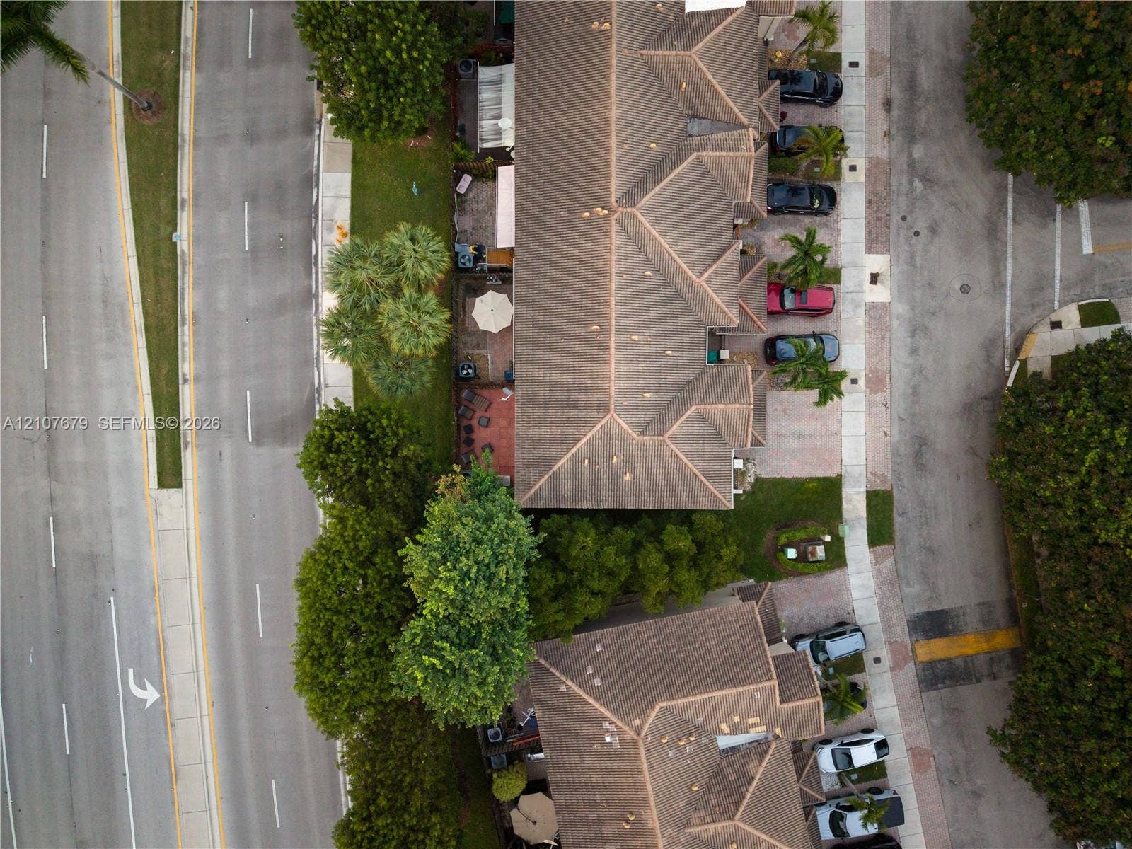 22066 SW 93rd Place, Cutler Bay, FL 33190 Aerial view of multi-unit residential complex featuring shingle roofing, paved parking areas, and mature landscaping