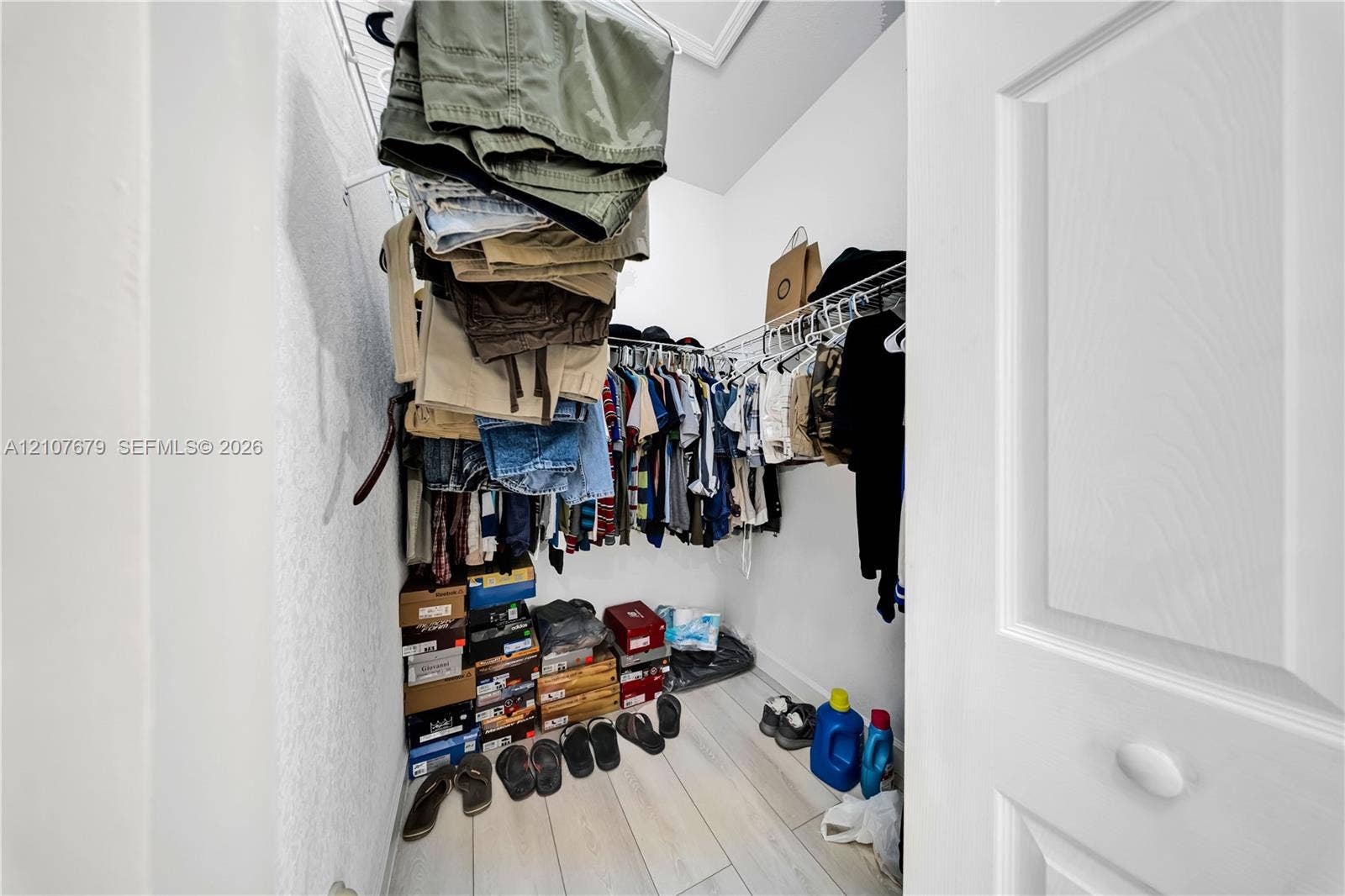 22066 SW 93rd Place, Cutler Bay, FL 33190 Storage closet featuring multi-level wire shelving and wood-finish flooring