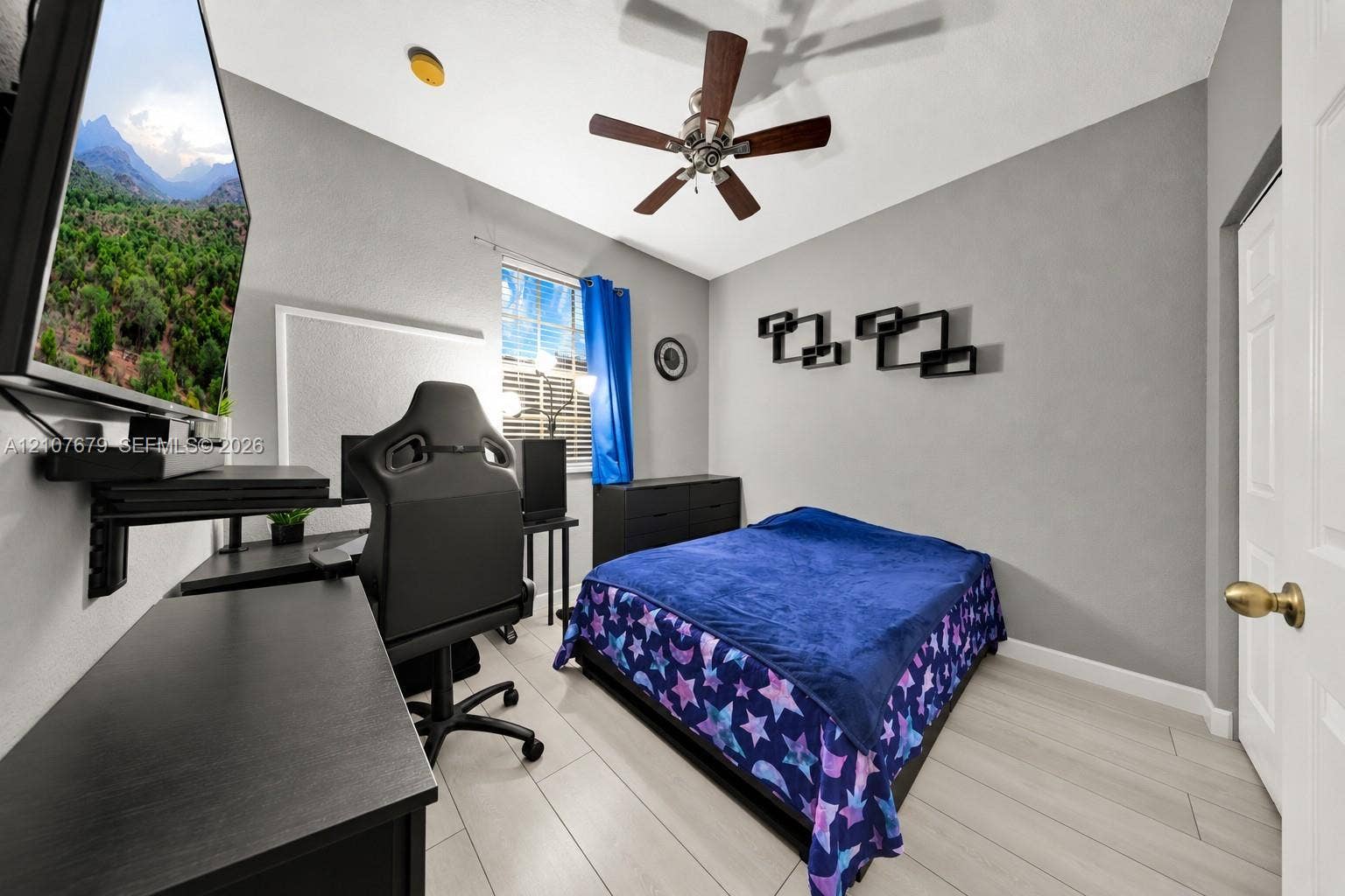 22066 SW 93rd Place, Cutler Bay, FL 33190 Room featuring wood-finish flooring, a multi-blade ceiling fan, and a single-pane window