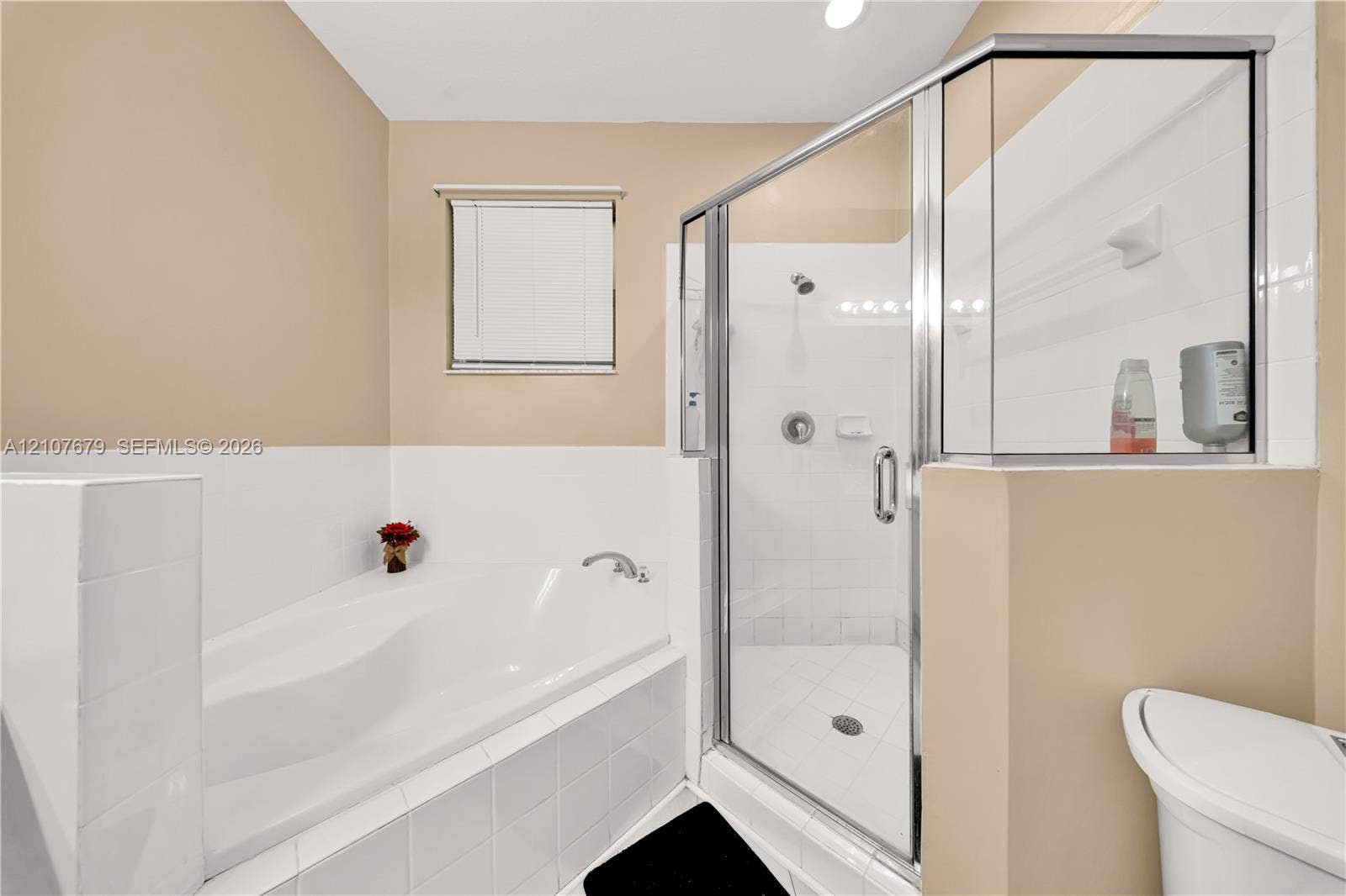 22066 SW 93rd Place, Cutler Bay, FL 33190 Corner soaking tub with tile surround, glass-enclosed shower, and polished chrome fixtures