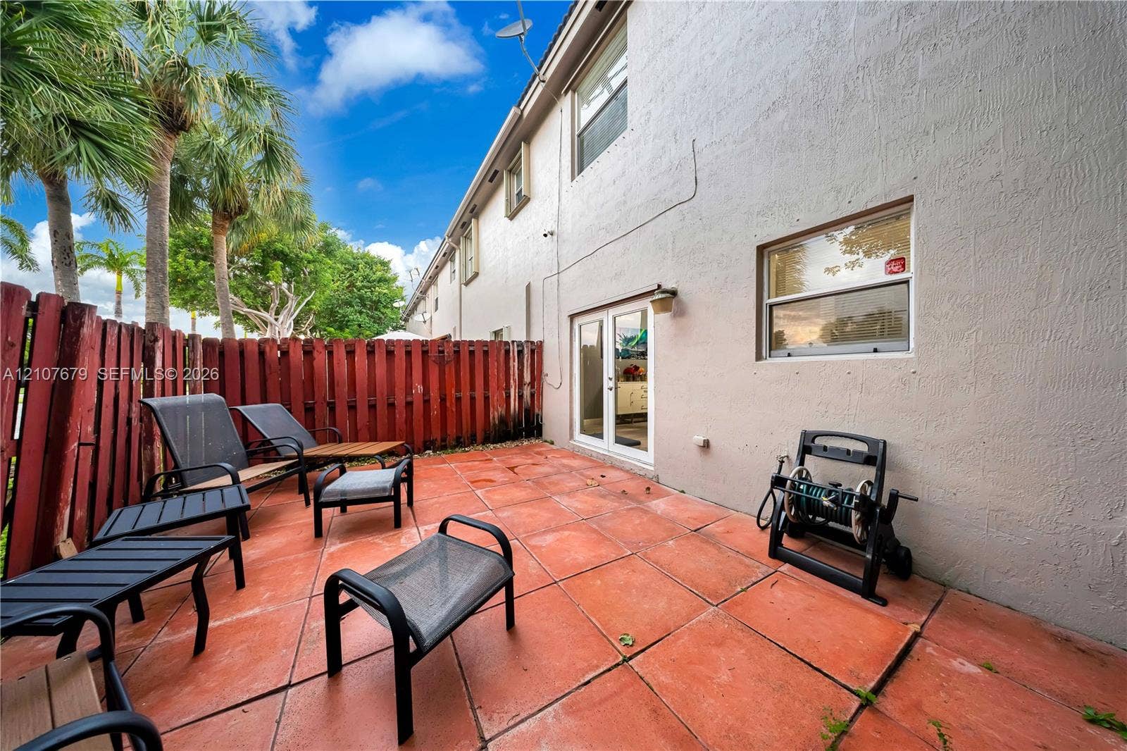 22066 SW 93rd Place, Cutler Bay, FL 33190 Room featuring tray ceiling, wood-finish flooring, and a ceiling fan with integrated lighting