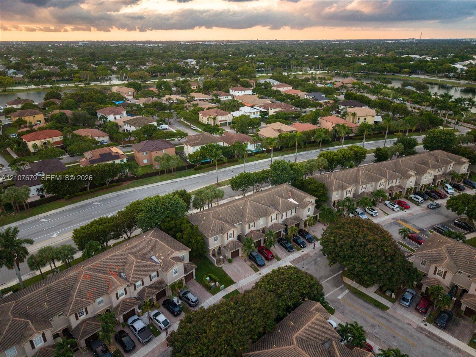 22066 SW 93rd Place, Cutler Bay, FL 33190 Aerial perspective of a multi-unit residential community featuring pitched tile roofs, paved driveways, and mature landscaping