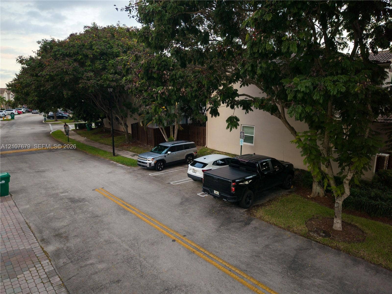 22066 SW 93rd Place, Cutler Bay, FL 33190 Exterior featuring designated surface parking, paved street access, and mature canopy trees