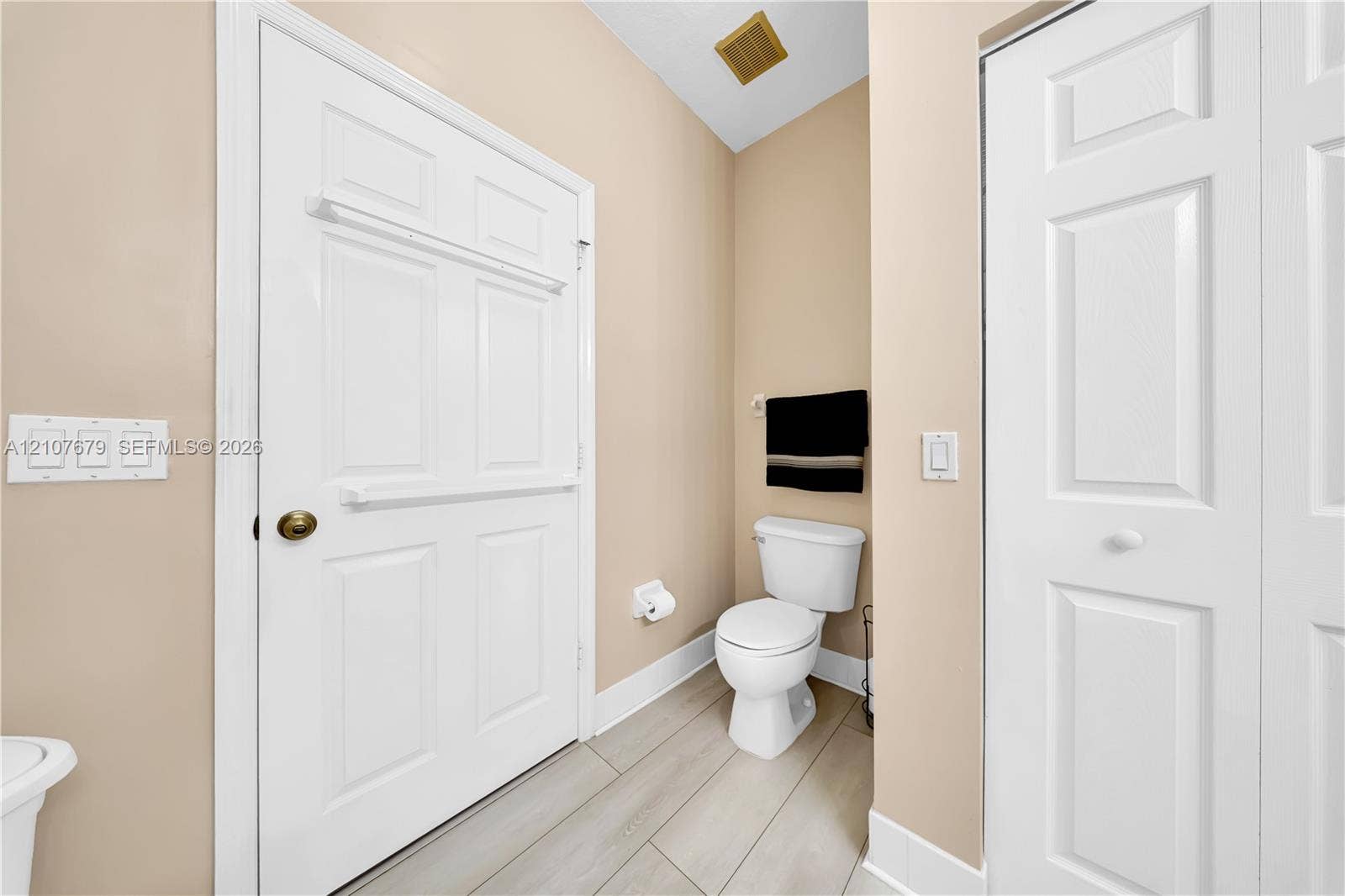 22066 SW 93rd Place, Cutler Bay, FL 33190 Wood-finish flooring, two-panel interior doors, and a porcelain toilet