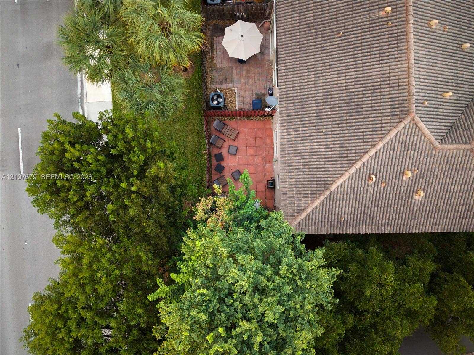 22066 SW 93rd Place, Cutler Bay, FL 33190 Outdoor space featuring a paved patio, perimeter fencing, and mature trees