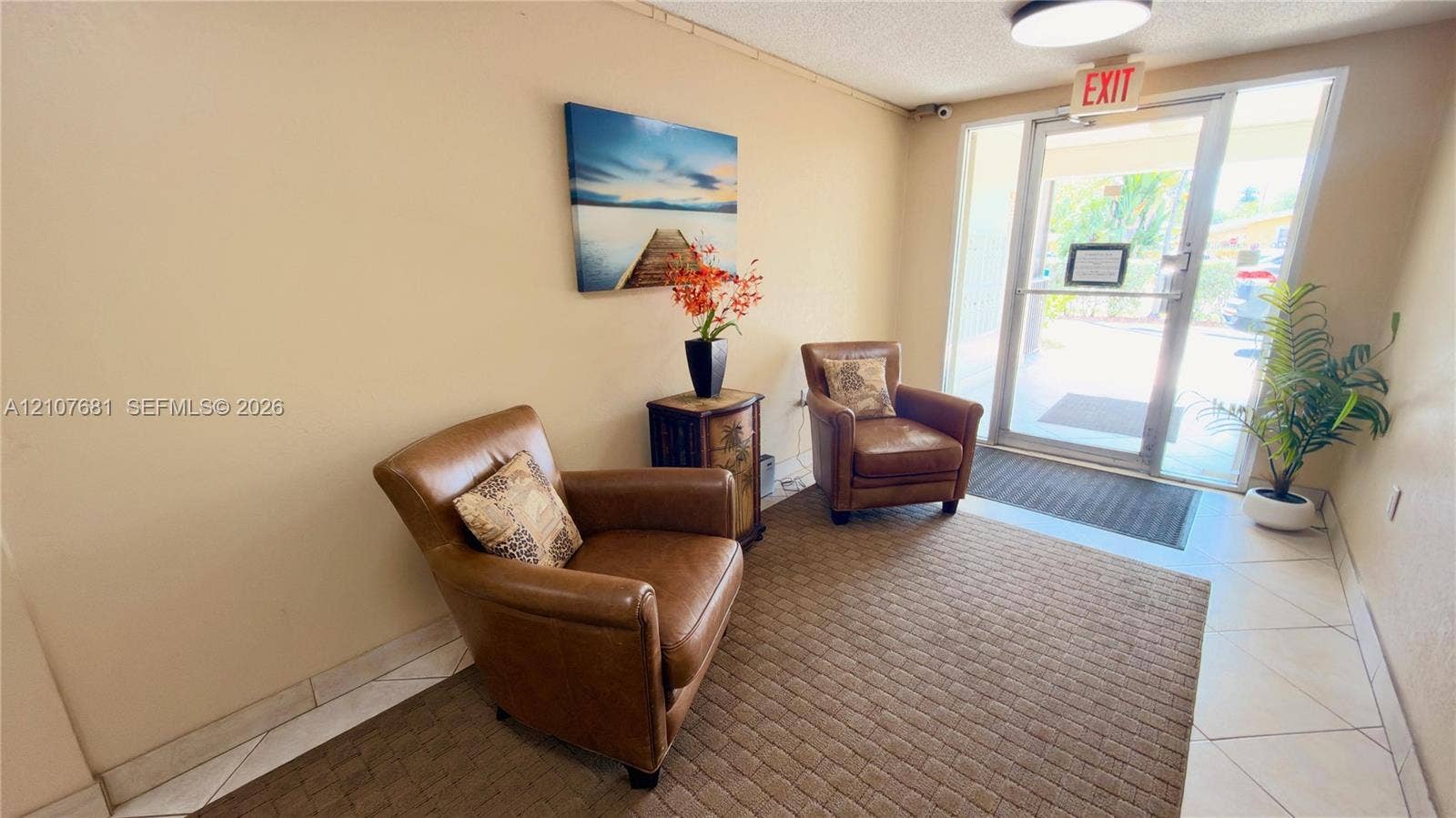 701 NE 1st Court, #202, Hallandale Beach, Hallandale Beach, FL 33009 Entryway featuring ceramic tile flooring, a glass-panel commercial entry door, and a flush-mount ceiling light fixture