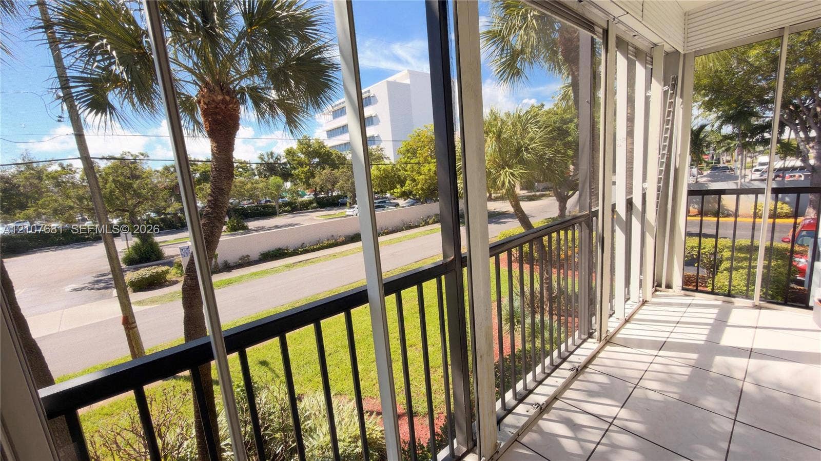 701 NE 1st Court, #202, Hallandale Beach, Hallandale Beach, FL 33009 Screened-in balcony featuring tile flooring and metal railing