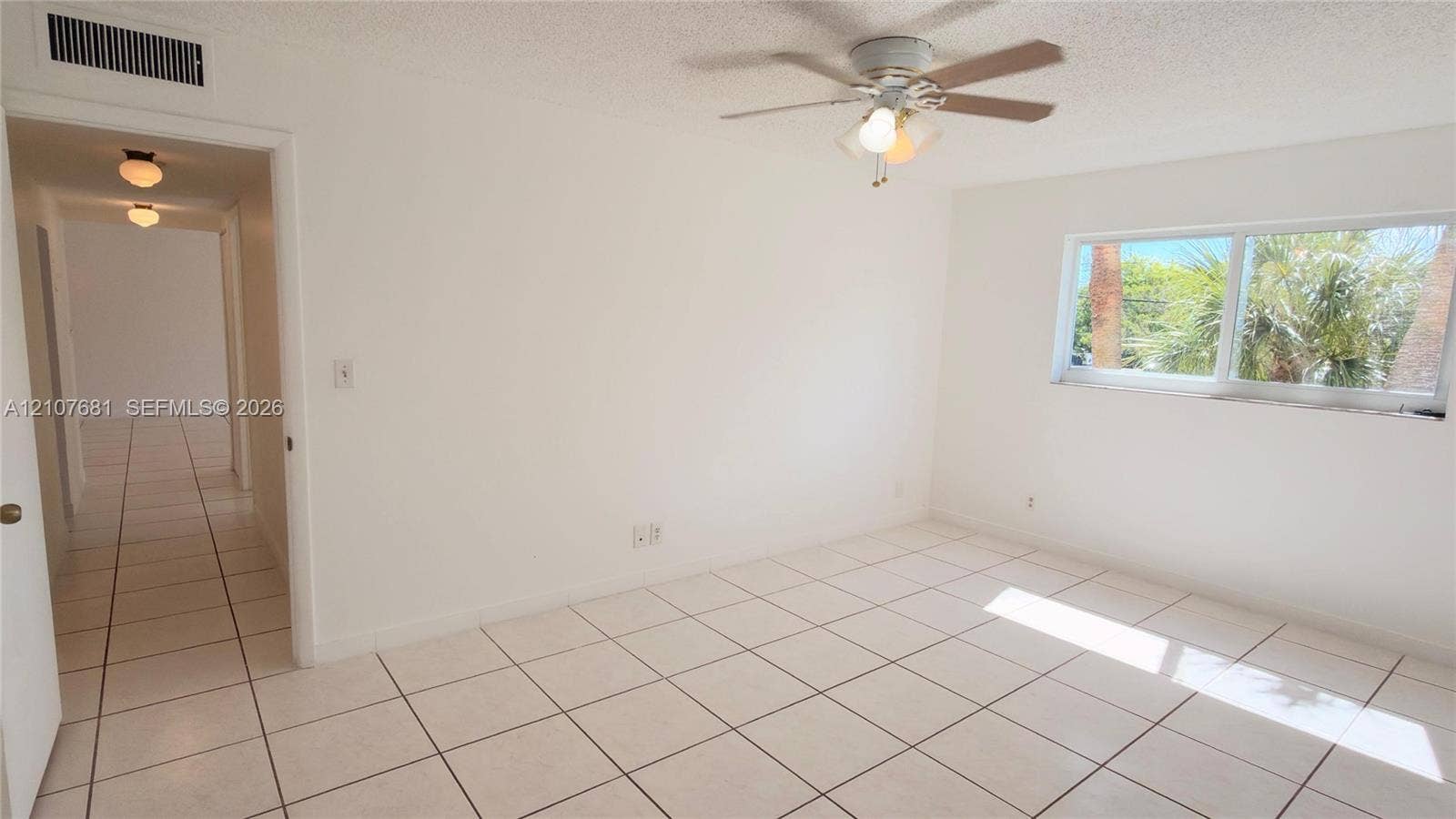 701 NE 1st Court, #202, Hallandale Beach, Hallandale Beach, FL 33009 Interior space featuring large-format tile flooring, a multi-blade ceiling fan with integrated lighting, and a wide sliding window